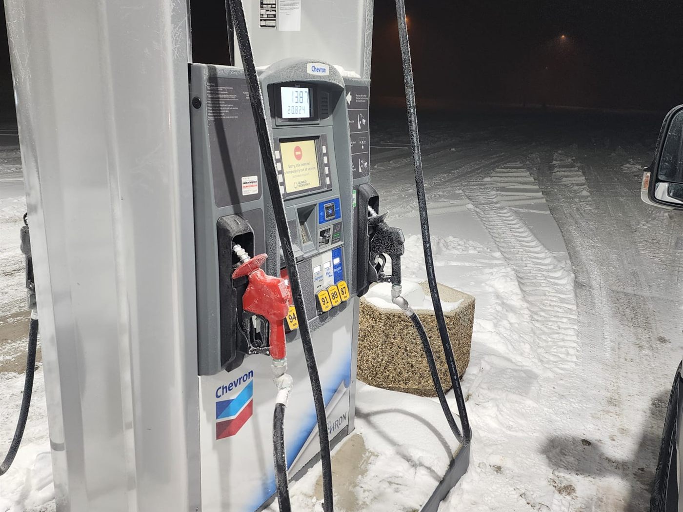 Close-up of a Chevron dispenser with hoses and nozzle