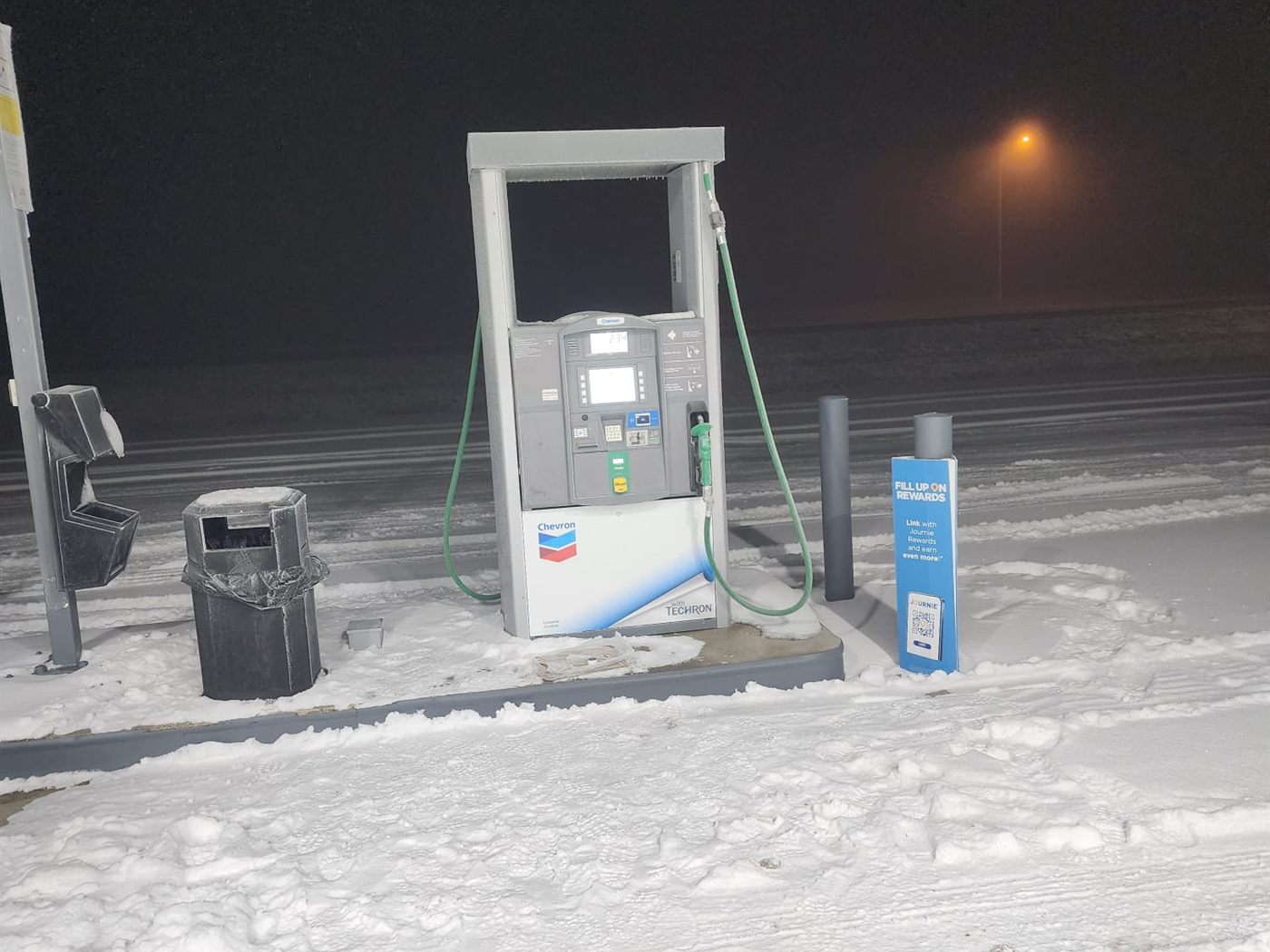 Single Chevron fuel dispenser on its island at night