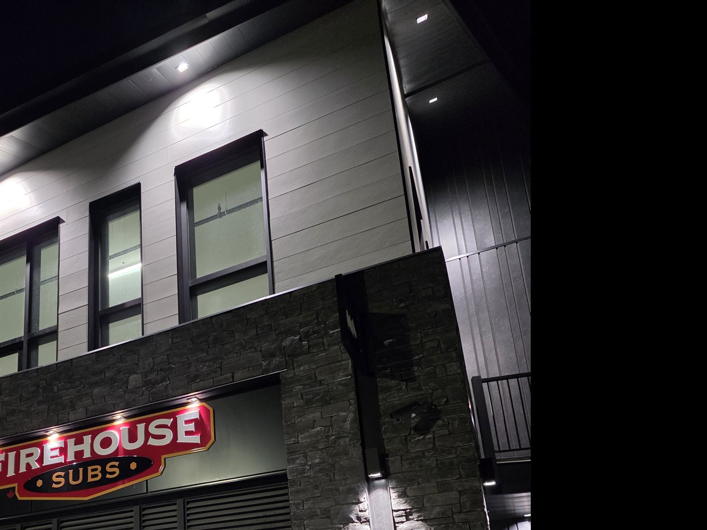 Firehouse Subs storefront lit at night in Canmore, Alberta