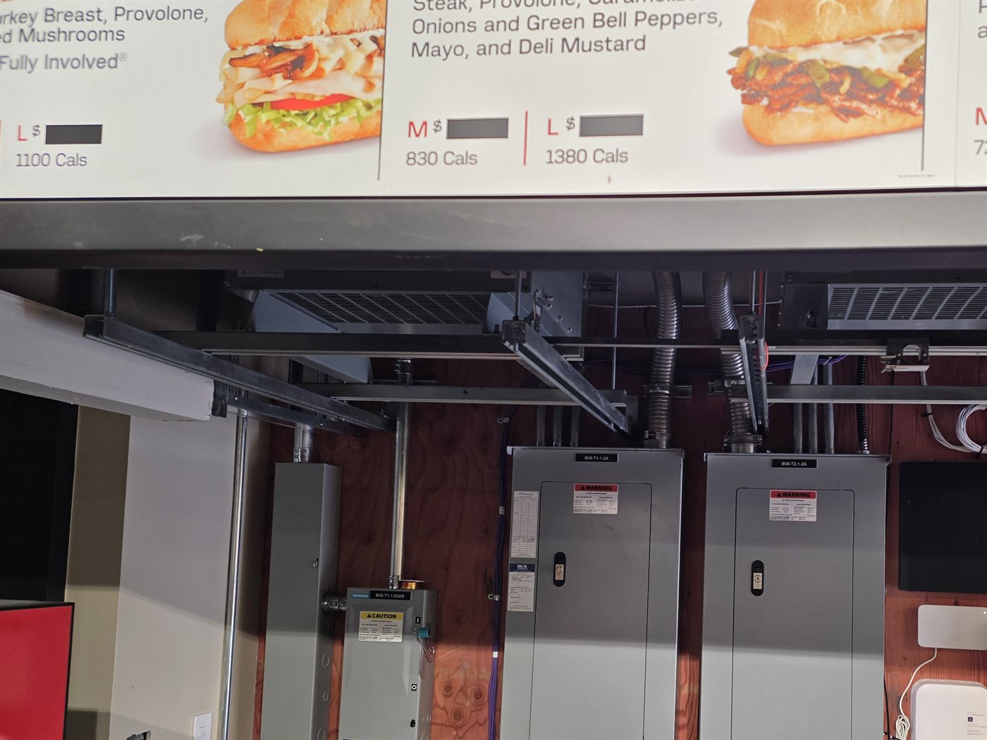 Service panels and distribution equipment in a restaurant electrical room
