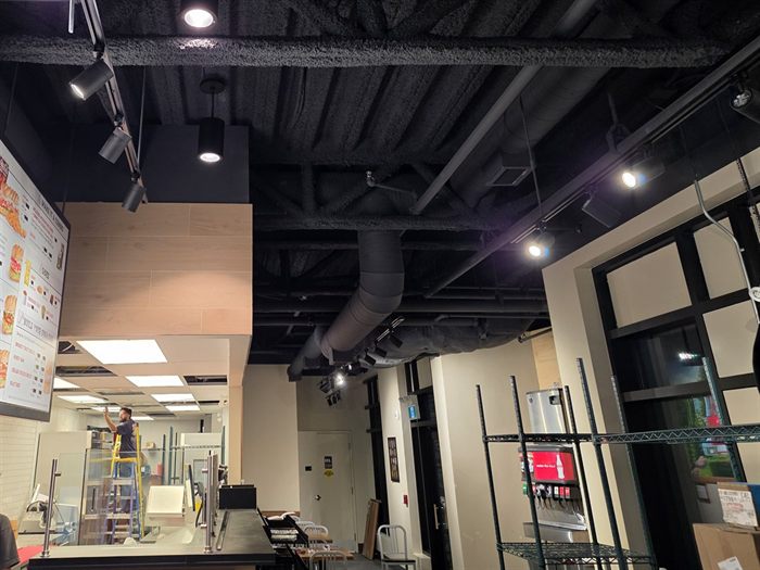 Ceiling cable tray and raceway installed above a restaurant menu board