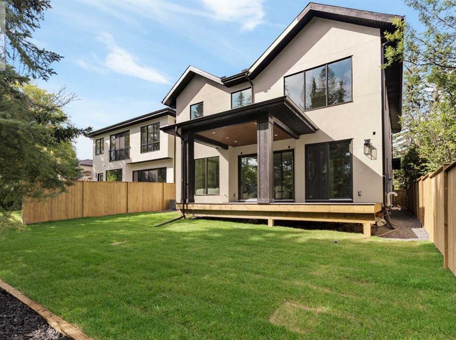 Rear exterior and covered deck of a custom home in Lakeview, Calgary