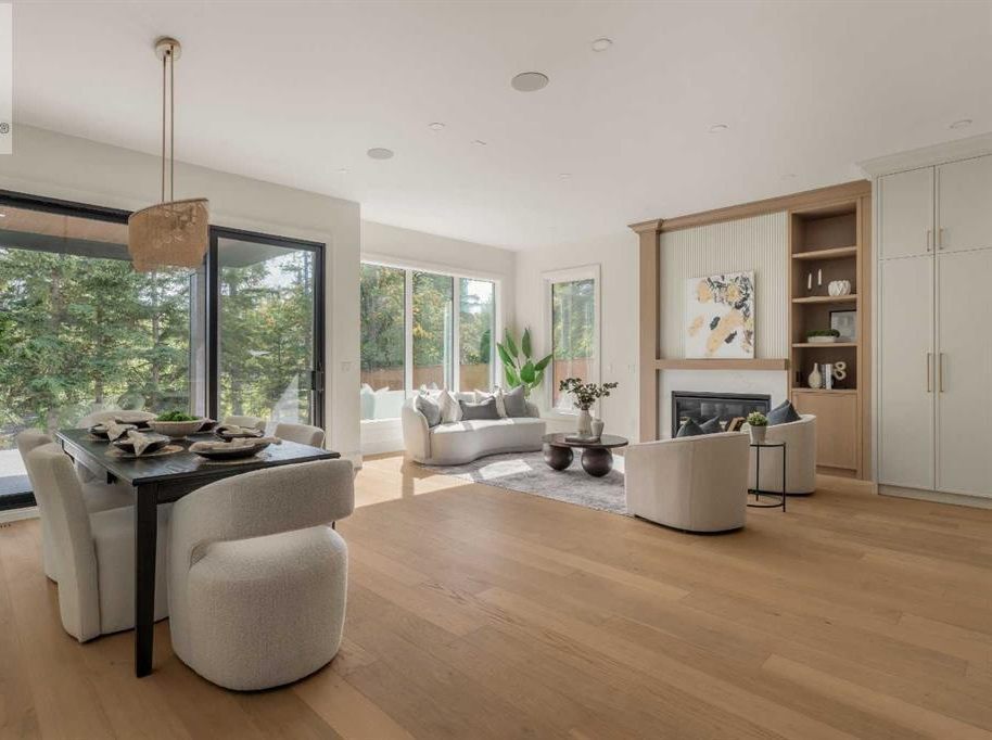 Open dining and living area with wide windows and built-in shelving