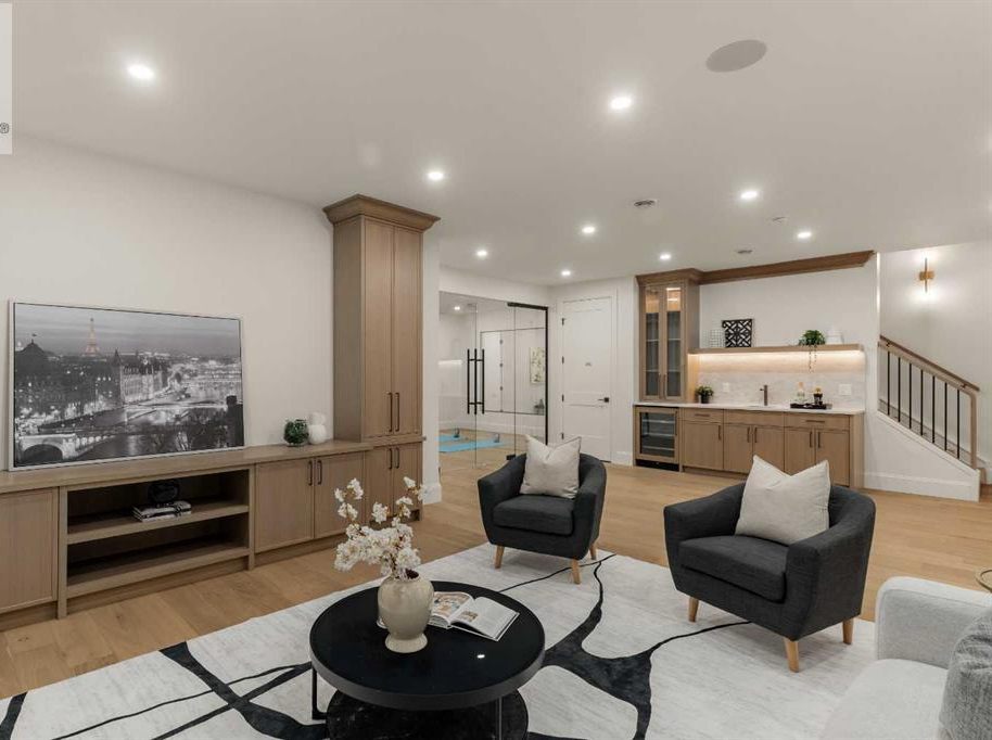 Finished basement recreation room with fireplace and media wall