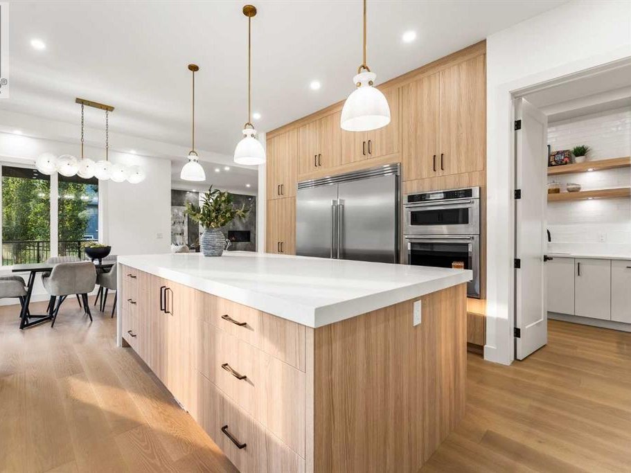Kitchen with large island, pendant lights, and under-cabinet lighting