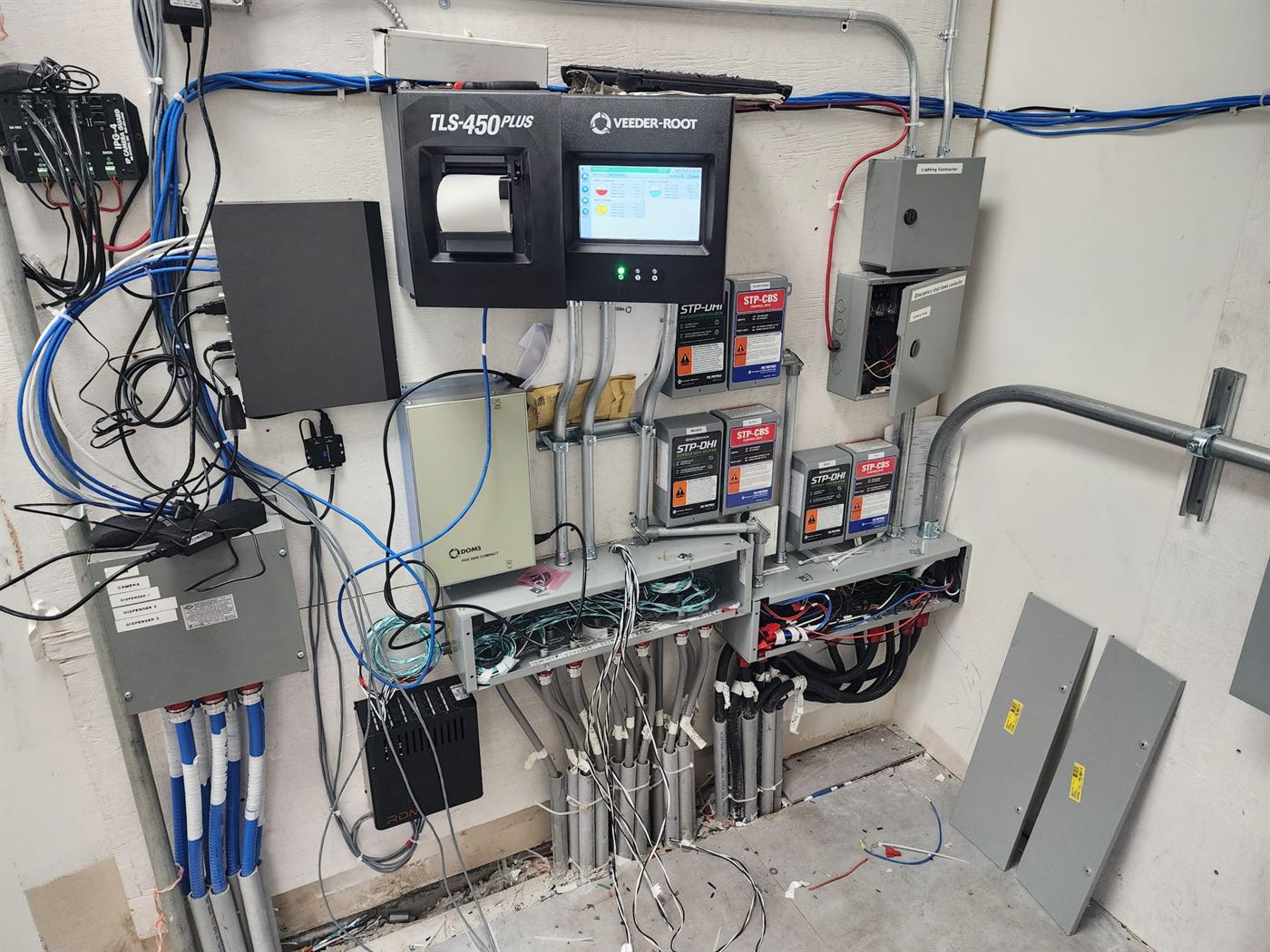 Tank monitoring and dispenser control wall with a Veeder-Root TLS-450 and STP controllers